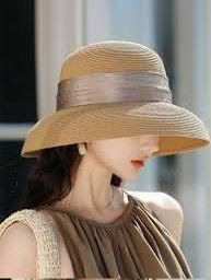 Shein Beige Rafia Sun Hat (Category: Hats & Beanies) located in Binan City. Submitted by myprelovedhaul (Listing ID 1468071798, Image 1). Description: The image shows a tan or beige straw/rafia sun hat featuring a wide brim and a gathered metallic/satin ribbon band adorned with small sparkling or dotted accents.