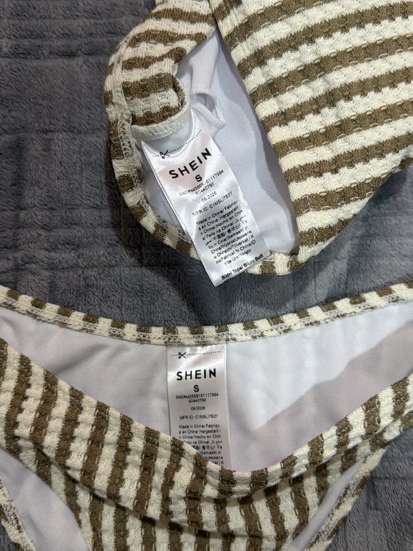 SHEIN Brown Striped One-Shoulder Bikini Set (Category: Bikinis & Swimsuits) located in Bulacan. Submitted by richelleregala (Listing ID 1468079219, Image 2). Description: - Brand new with tags attached, never worn - Brown and white vertical striped pattern - Textured waffle-knit fabric with clean white inner lining - One-shoulder top featuring a chic gold-tone ring detail - Matching bottoms in size small ONLY USED ONCE!!!.