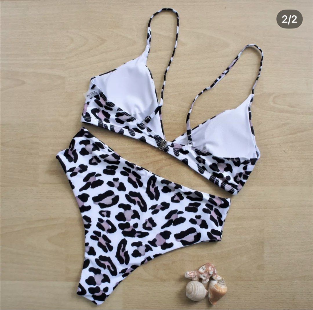 SHEIN Leopard Print High Waist Bikini Set Size L (Category: Bikinis & Swimsuits) located in Bulacan. Submitted by peach1025 (Listing ID 1468066794, Image 2). Description: - Brand: SHEIN - Condition: Brand new, never worn with tags attached - Size: L - Design: White base with black and pinkish-grey animal print - Top: Triangle style with adjustable thin straps and back clasp - Bottoms: High-waisted with high-cut legs - Material: 82% polyester, 18%