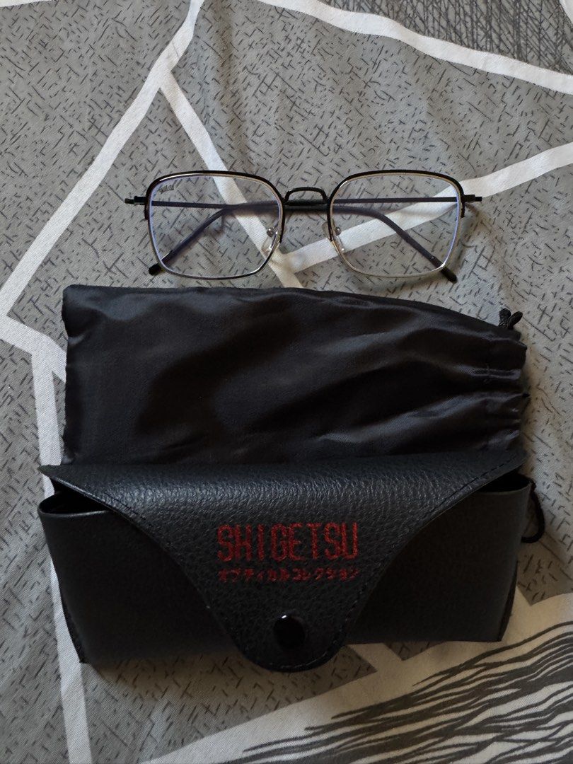 Shigetsu Eyewear Optical Bluelight Lens (Category: Sunglasses & Eyewear) located in Paranaque City. Submitted by matildascatalog (Listing ID 1468107599, Image 2). Description: - Brand: Shigetsu - Inclusions: 2 pairs of optical frames, 2 black leatherette hard case, 1 soft drawstring pouch, and 2 lens cleaners - Lenses: Clear with subtle blue tint coating - Durable metal hinges and silicone nose pads - Condition: Clean, excellent overall condition