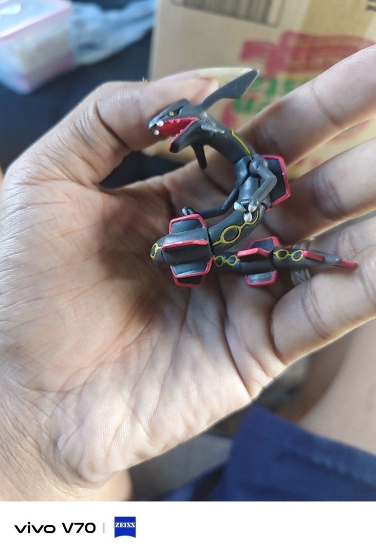 Shiny Rayquaza Pokémon Figure (Category: Figurines & Statues) located in Kapangan. Submitted by ClumZyDale (Listing ID 1468085006, Image 2). Description: - Shiny Rayquaza Pokémon mini figurine - Sleek black body with iconic red markings and yellow ring patterns - Features detailed head crest and tail fins - Ideal collectible for fans of the games and anime - Condition: Brand new / Great display piece.