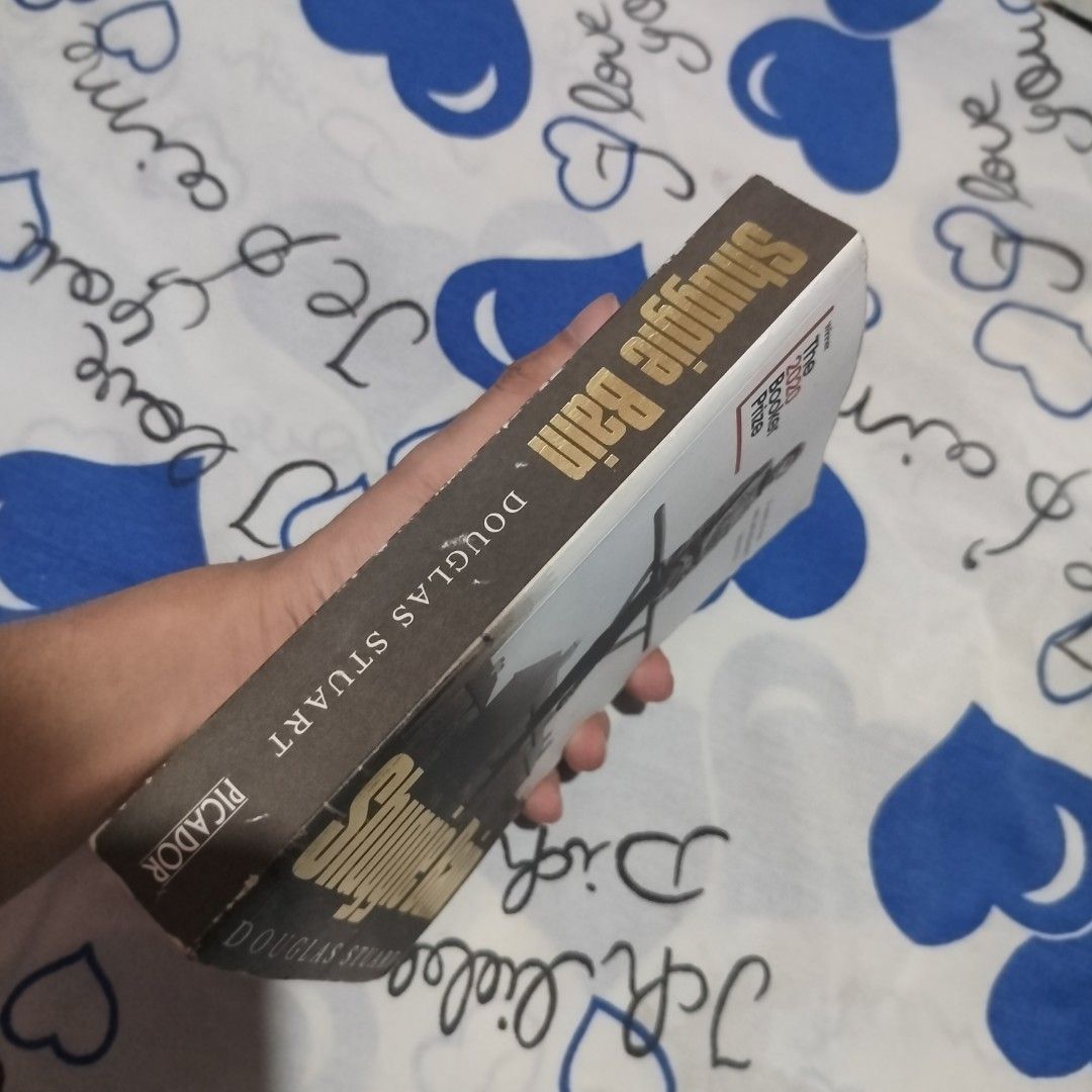 Shuggie Bain by Douglas Stuart (Category: Storybooks) located in Santa Maria. Submitted by shade.lost (Listing ID 1468174627, Image 3). Description: - Title & Author: Shuggie Bain by Douglas Stuart - Award: Winner of the 2020 Booker Prize - Format: Paperback (Picador edition) - Setting: 1980s Glasgow.