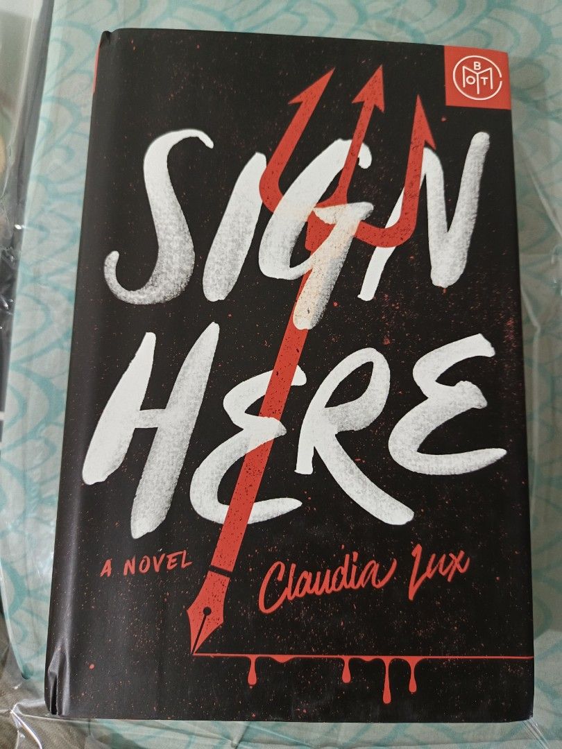 Sign Here by Claudia Lux Book (Category: Storybooks) located in Taguig. Submitted by joeeey23 (Listing ID 1468180328, Image 1). Description: - Title: Sign Here - Author: Claudia Lux - Edition: Hardcover, Book of the Month (October 2022) - Appearance: Black cover with striking red typography and trident design - ISBN: 978-0-593-54576-8 - Condition: Pages are completely intact with clean edges.