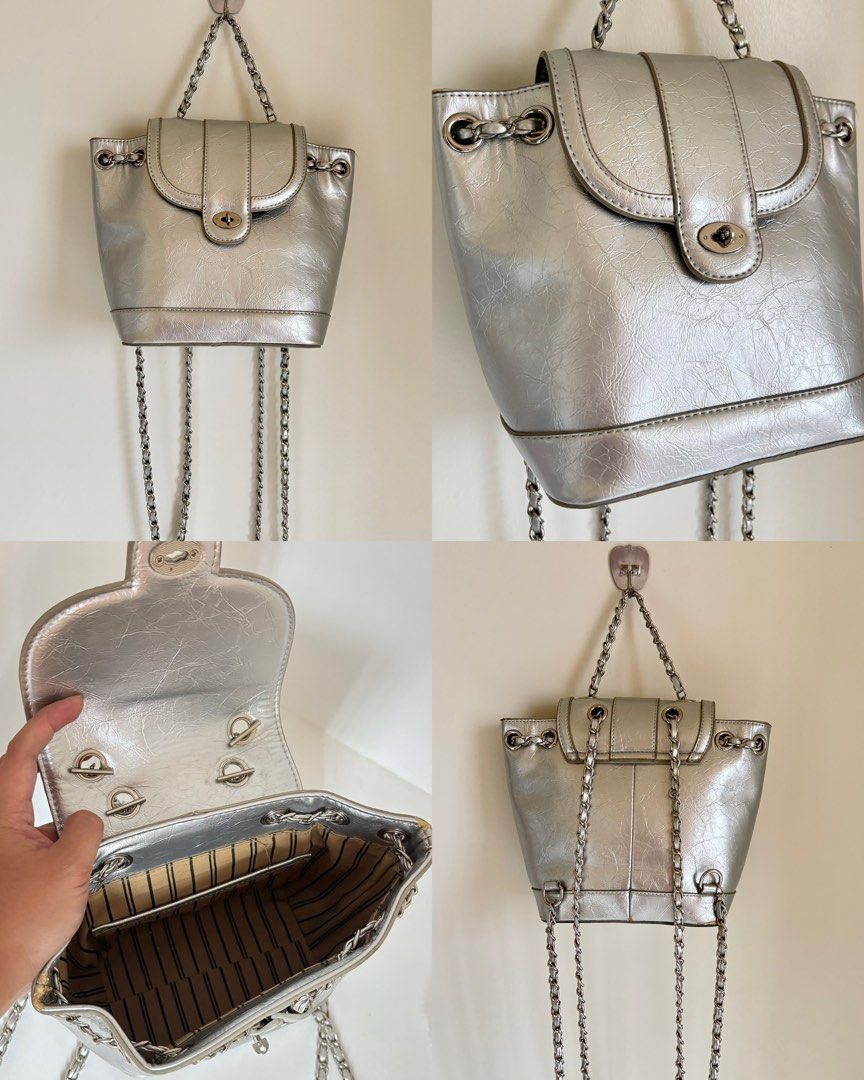 Silver metallic mini backpack with chain straps (Category: Backpacks) located in Baguio. Submitted by zenforest.fd186d (Listing ID 1468224986, Image 1). Description: Silver metallic mini backpack with a crinkled texture. - Twist-lock closure on the front flap. - Chain straps and top handle in silver-tone hardware. Inside is lined with striped fabric and includes a small slip pocket. - Hardware has a few minor scuffs, but overall clean shape..