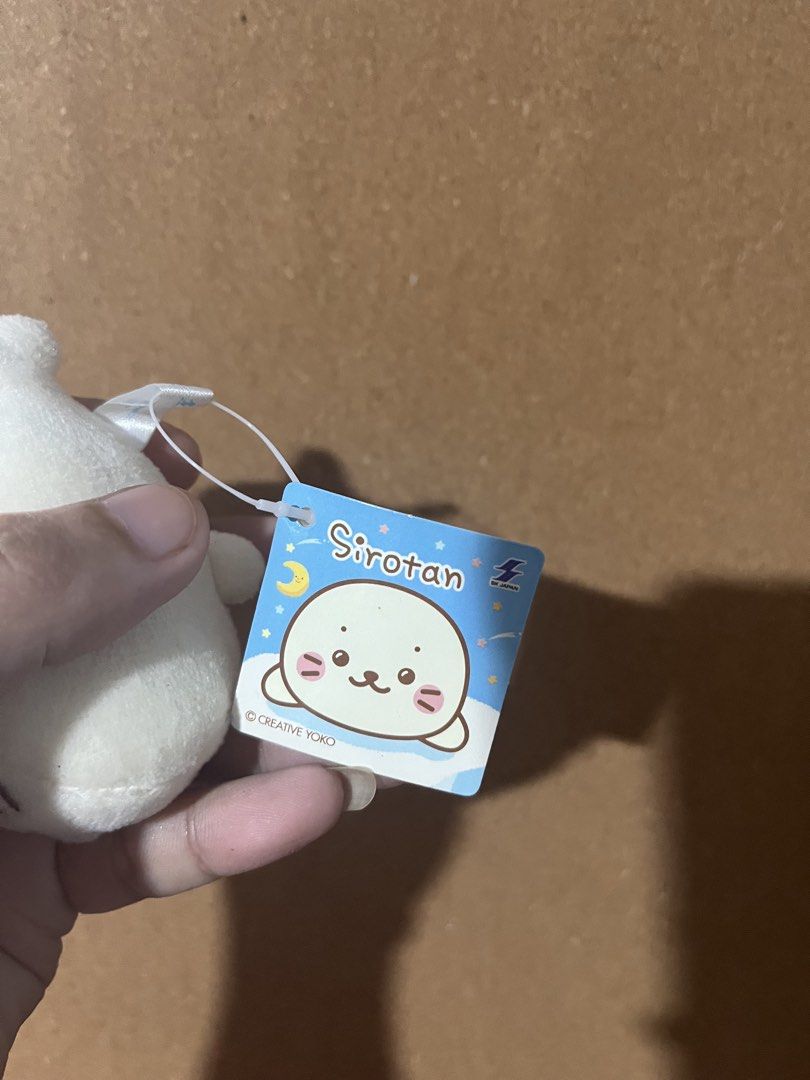 Sirotan Seal Plush Toy with Tag (Category: Plushies & Soft Toys) located in Baguio. Submitted by gaara1234 (Listing ID 1463353874, Image 3). Description: - Cute white Sirotan plush toy - Comes with original tag - Soft and squishy texture - Ideal for collectors or as a gift - Perfect size for hanging on bags/backpacks - Features a yellow loop for easy hanging.