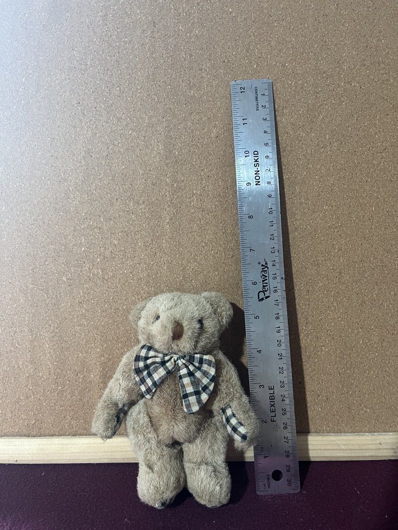 Small Plush Teddy Bear with Plaid Bow (Category: Plushies & Soft Toys) located in Baguio. Submitted by gaara1234 (Listing ID 1468283175, Image 1). Description: - Adorable 5-inch mini teddy bear - Made from super soft, fuzzy brown material - Features a chic black, beige, and white checkered bow tie - Matching checkered pattern on both paws - Perfect for gifts, collections, or as a cute cuddle buddy.