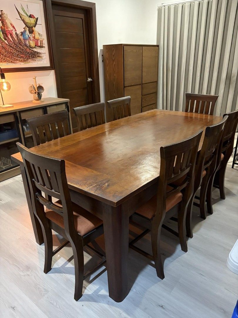 Solid narra dining table set with 8 chairs (Category: Tables & Sets) located in Taytay. Submitted by ljtumabini (Listing ID 1468120173, Image 2). Description: - Type: Solid narra dining table and 8 chairs: Table size : H: 75cm L: 198cm W: 105cm Chair size: H 47cm (including backrest 95cm) seat is 40cm x 44cm - Color/Finish: Rich brown wood with burnt orange fabric cushions - Capacity: Comfortably seats eight people - Style: Versatile design suits