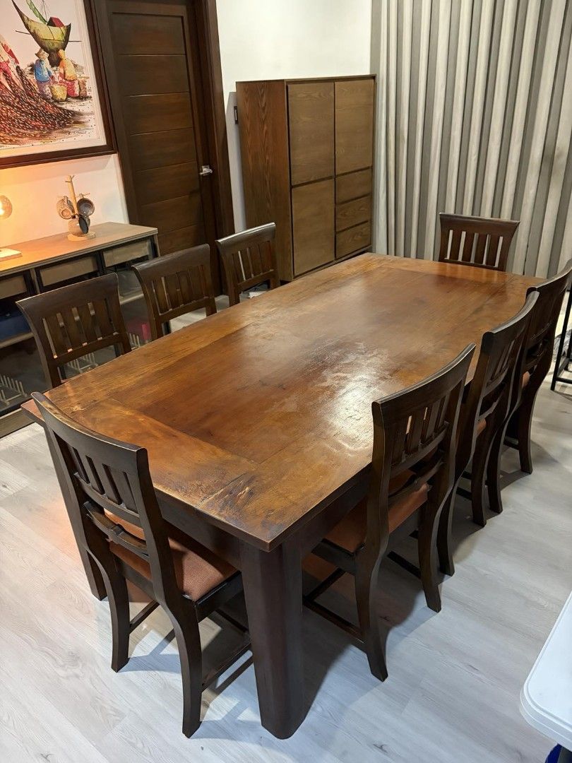Solid narra dining table set with 8 chairs (Category: Tables & Sets) located in Taytay. Submitted by ljtumabini (Listing ID 1468120173, Image 1). Description: - Type: Solid narra dining table and 8 chairs: Table size : H: 75cm L: 198cm W: 105cm Chair size: H 47cm (including backrest 95cm) seat is 40cm x 44cm - Color/Finish: Rich brown wood with burnt orange fabric cushions - Capacity: Comfortably seats eight people - Style: Versatile design suits