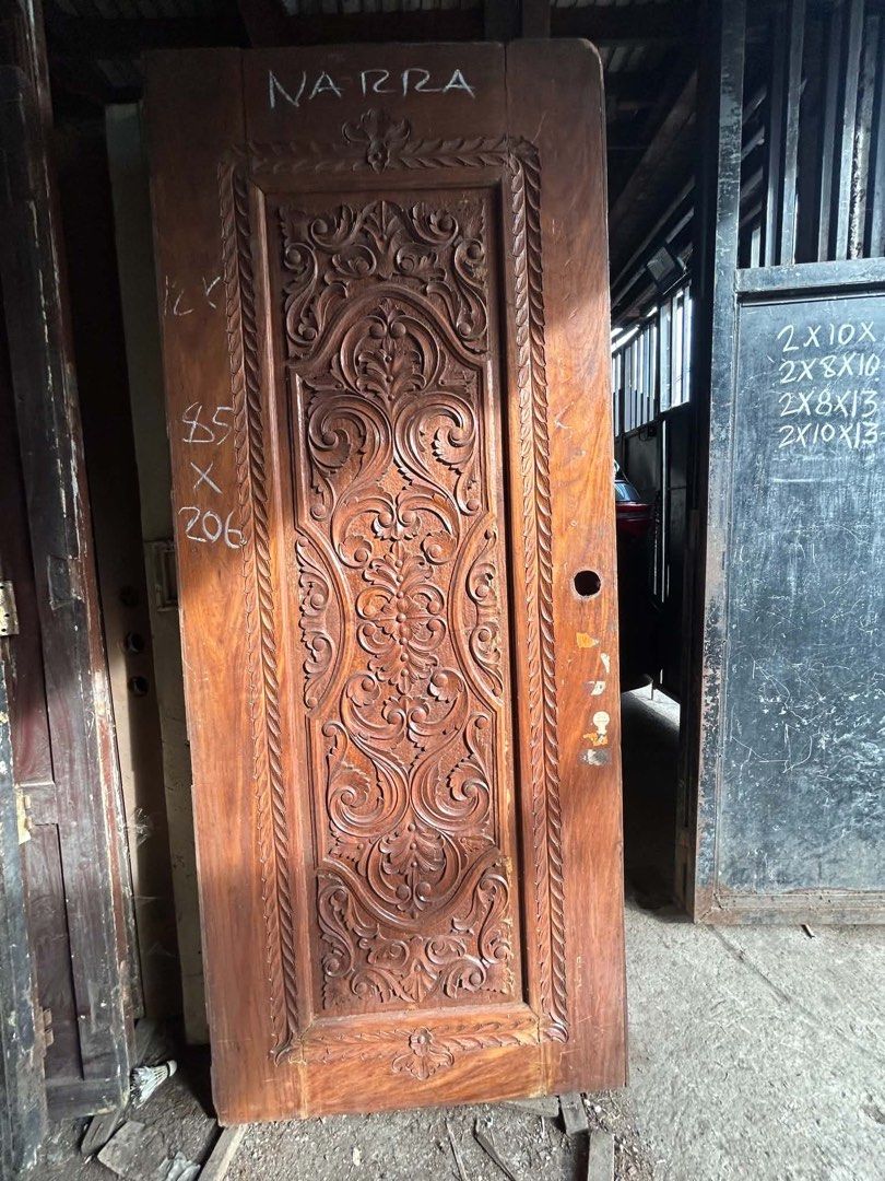Solid Narra Wood Carved Door (Category: Locks, Doors & Gates) located in Manila. Submitted by kaikaiii- (Listing ID 1468234646, Image 2). Description: 2nd hand narra doors for sale 12k each slightly negotiable. big discount if take all. for pickup only. open for delivery thru lalamove or transportify payment upon pickup. - Material: Solid Narra wood with a natural finish - Design: Detailed traditional hand carvings across the front panel - Note: 