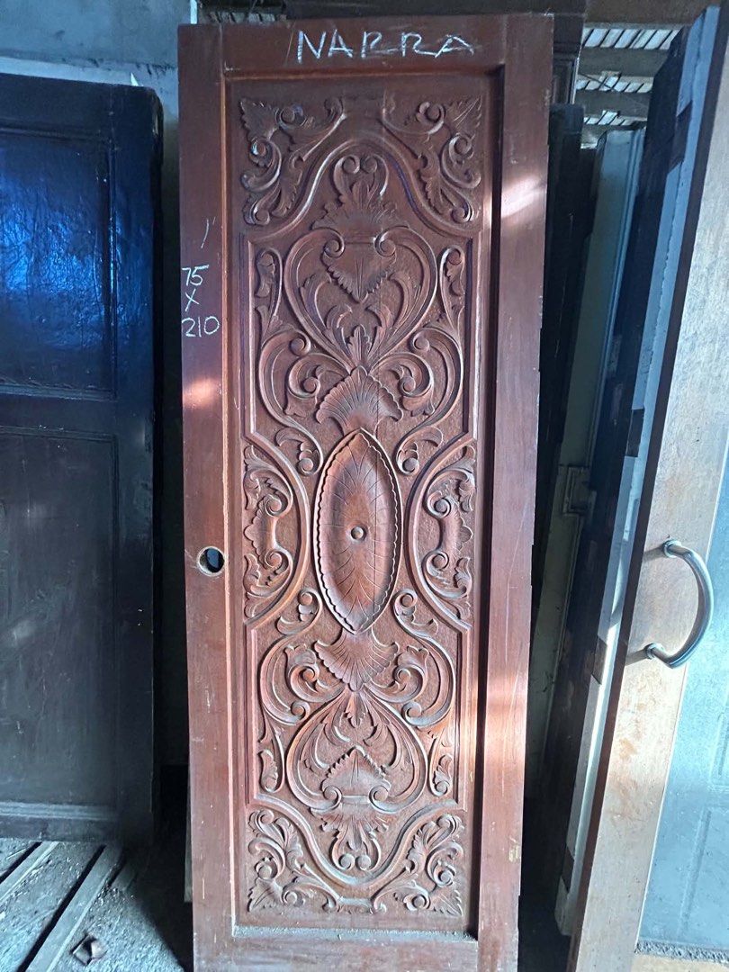 Solid Narra Wood Carved Door (Category: Locks, Doors & Gates) located in Manila. Submitted by kaikaiii- (Listing ID 1468234646, Image 1). Description: 2nd hand narra doors for sale 12k each slightly negotiable. big discount if take all. for pickup only. open for delivery thru lalamove or transportify payment upon pickup. - Material: Solid Narra wood with a natural finish - Design: Detailed traditional hand carvings across the front panel - Note: 