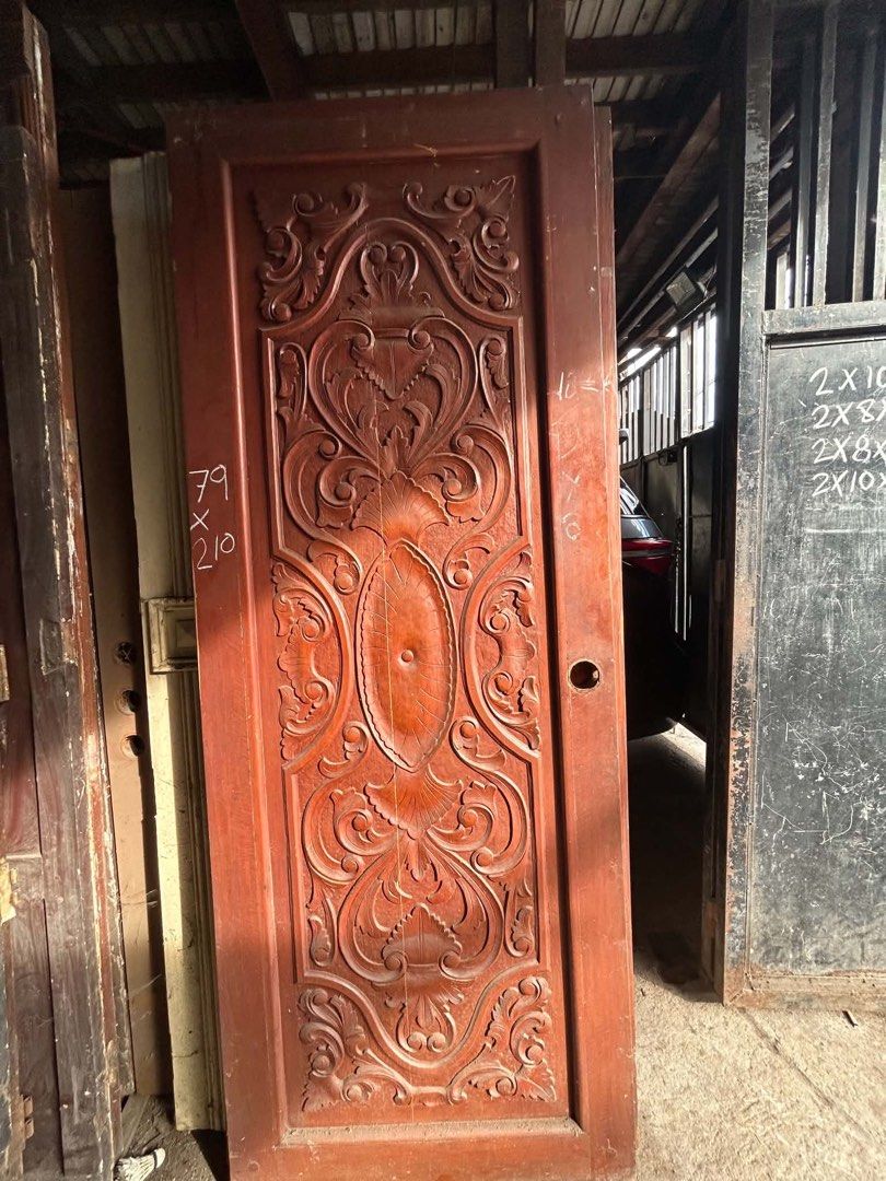 Solid Narra Wood Carved Door (Category: Locks, Doors & Gates) located in Manila. Submitted by kaikaiii- (Listing ID 1468234646, Image 3). Description: 2nd hand narra doors for sale 12k each slightly negotiable. big discount if take all. for pickup only. open for delivery thru lalamove or transportify payment upon pickup. - Material: Solid Narra wood with a natural finish - Design: Detailed traditional hand carvings across the front panel - Note: 