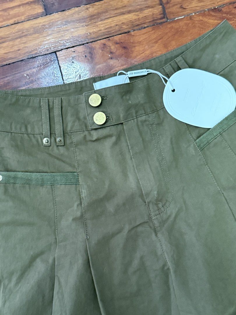 Something Else Olive Green Wide Leg Culotte Shorts (Category: Shorts) located in Pasig City. Submitted by atbp__ (Listing ID 1468093622, Image 2). Description: - Brand: Something Else - Condition: Brand new with tags (Unworn) - Color: Olive green - Style: High waist culotte shorts with double gold-tone buttons and front pleats - Details: Horizontal panelling near the hem - Pockets: Functional side pockets and back welt pockets.