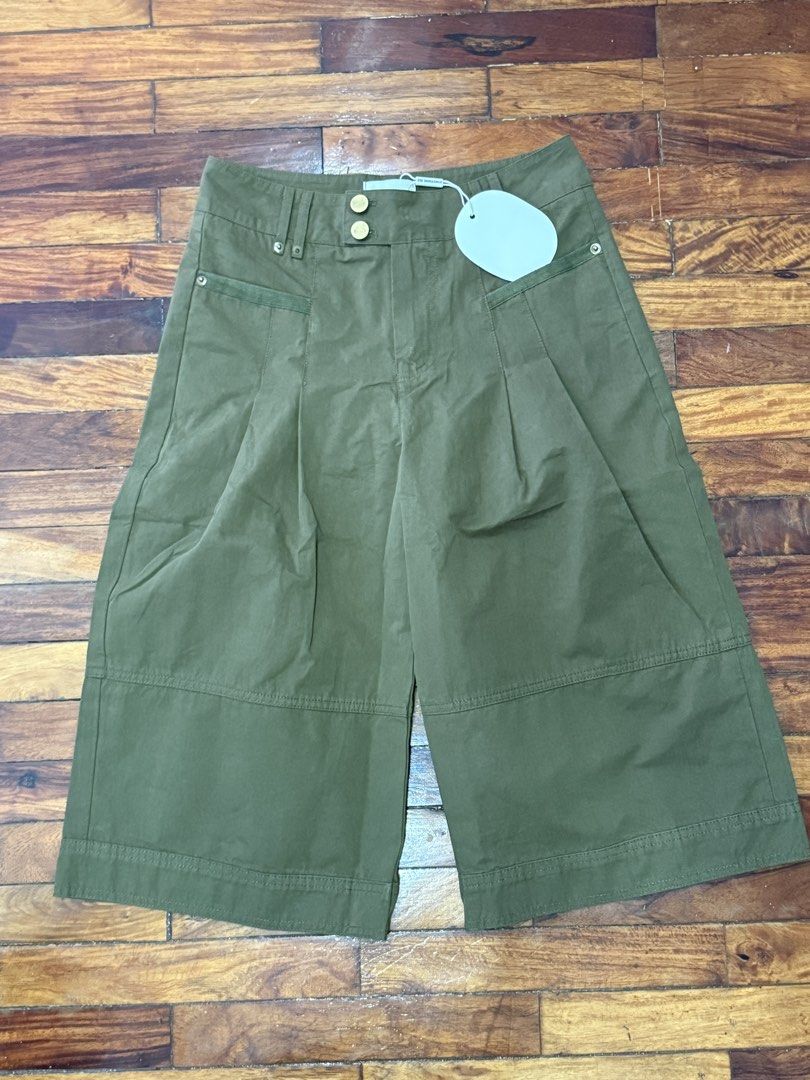 Something Else Olive Green Wide Leg Culotte Shorts (Category: Shorts) located in Pasig City. Submitted by atbp__ (Listing ID 1468093622, Image 1). Description: - Brand: Something Else - Condition: Brand new with tags (Unworn) - Color: Olive green - Style: High waist culotte shorts with double gold-tone buttons and front pleats - Details: Horizontal panelling near the hem - Pockets: Functional side pockets and back welt pockets.