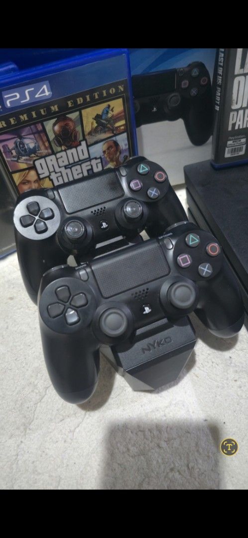 Sony DualShock 4 Wireless Controllers with Nyko Charging Dock (Category: Controllers) located in Manila. Submitted by benzcreen49158 (Listing ID 1468188681, Image 2). Description: - 2 Official Sony PlayStation 4 DualShock 4 Wireless Controllers (Standard Black) - Includes a Nyko charging station for easy power-ups - Rubber thumbsticks show moderate wear on the top controller; bottom controller is cleaner - Fully functional and ready for multiplay