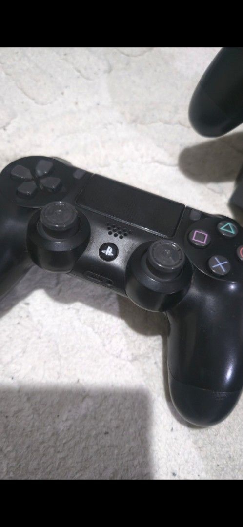 Sony DualShock 4 Wireless Controllers with Nyko Charging Dock (Category: Controllers) located in Manila. Submitted by benzcreen49158 (Listing ID 1468188681, Image 1). Description: - 2 Official Sony PlayStation 4 DualShock 4 Wireless Controllers (Standard Black) - Includes a Nyko charging station for easy power-ups - Rubber thumbsticks show moderate wear on the top controller; bottom controller is cleaner - Fully functional and ready for multiplay