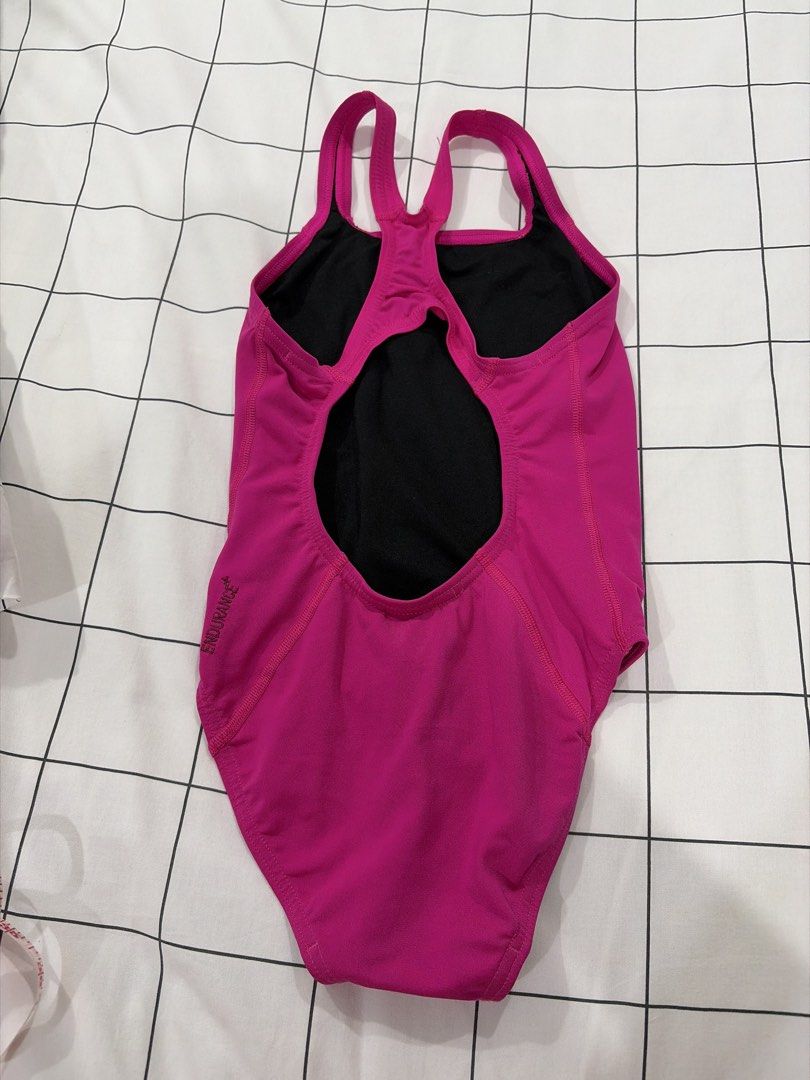 Speedo Endurance Pink One-Piece Swimsuit (Category: Babies & Kids Fashion) located in Manila. Submitted by handmdown (Listing ID 1468189143, Image 2). Description: - Brand: Speedo - Color: Bright pink with black lining - Material: Chlorine-resistant Speedo Endurance fabric - Design: Thin double straps with a stylish keyhole cutout at the back - Details: Speedo logo on the chest and Endurance text on the lower back - Best for: Lap swimming and tra