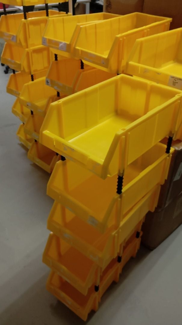 Stackable Yellow Plastic Storage Bins with Riser Posts (Category: Storage Boxes & Baskets) located in Singapore. Submitted by givinglifetousedthings (Listing ID 1468152459, Image 3). Description: - Vibrant yellow stackable storage bins with secure black riser posts - Open-front design for quick and easy item retrieval - Sturdy construction, perfect for organizing garages, warehouses, or craft supplies - Condition: Minor scuffs and marks from norm