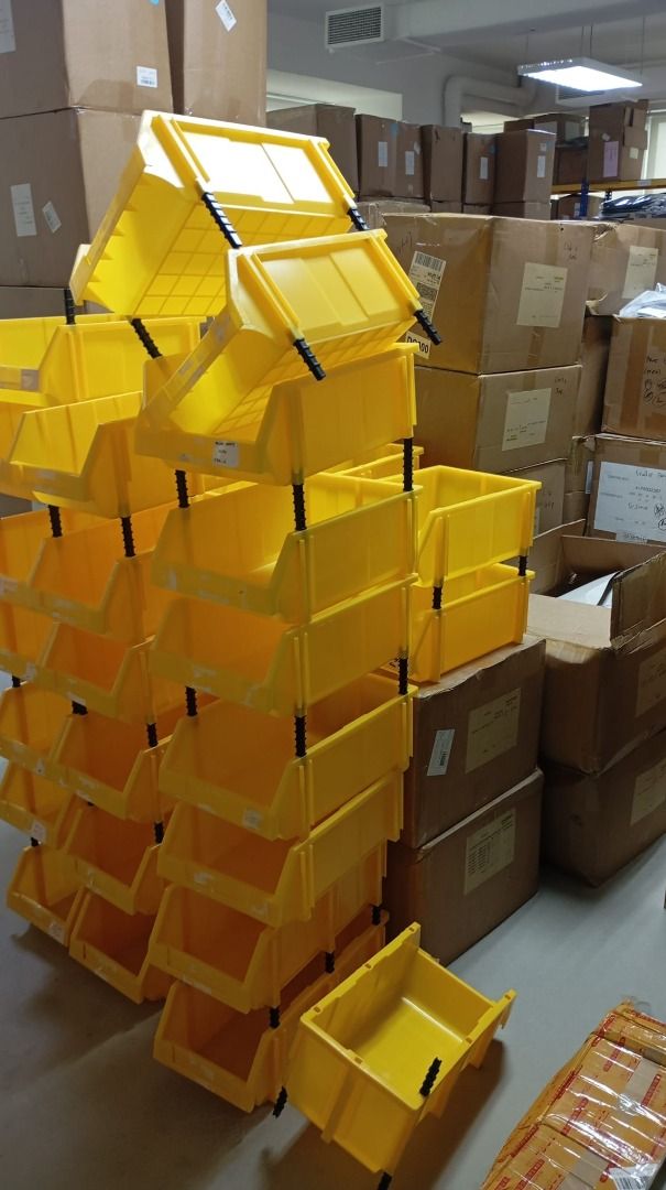 Stackable Yellow Plastic Storage Bins with Riser Posts (Category: Storage Boxes & Baskets) located in Singapore. Submitted by givinglifetousedthings (Listing ID 1468152459, Image 2). Description: - Vibrant yellow stackable storage bins with secure black riser posts - Open-front design for quick and easy item retrieval - Sturdy construction, perfect for organizing garages, warehouses, or craft supplies - Condition: Minor scuffs and marks from norm