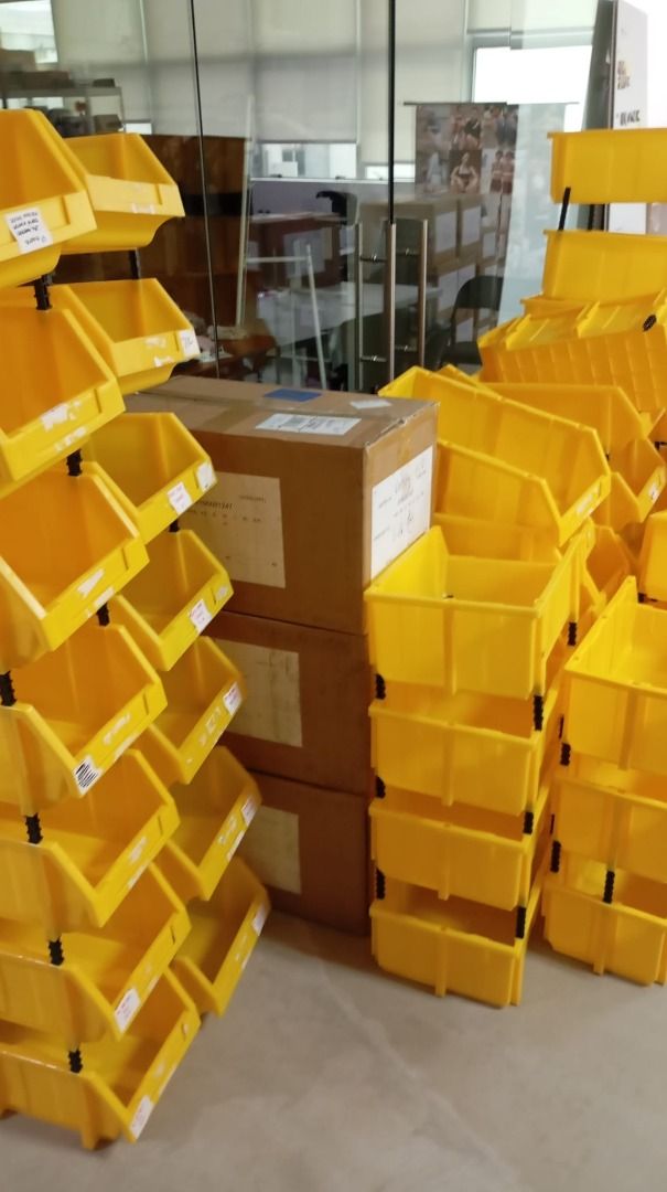 Stackable Yellow Plastic Storage Bins with Riser Posts (Category: Storage Boxes & Baskets) located in Singapore. Submitted by givinglifetousedthings (Listing ID 1468152459, Image 1). Description: - Vibrant yellow stackable storage bins with secure black riser posts - Open-front design for quick and easy item retrieval - Sturdy construction, perfect for organizing garages, warehouses, or craft supplies - Condition: Minor scuffs and marks from norm