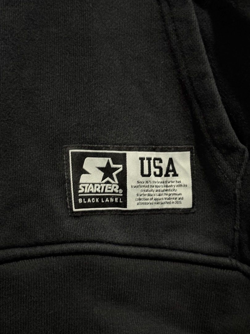 Starter Black Label USA Logo Hoodie (Category: Hoodies) located in Santo Tomas. Submitted by miguelhussle (Listing ID 1468059643, Image 3). Description: - Brand: Starter Black Label - 28 L x 22 W - 9.3/10 Colorrate - Color: Black - Size: Medium (Regular Fit) - Material: 100% Cotton - Details: Embroidered chest and pocket logo patches, drawstring hood, front kangaroo pocket, and side seam woven tag - Condition: Clean interior tags, made in China -