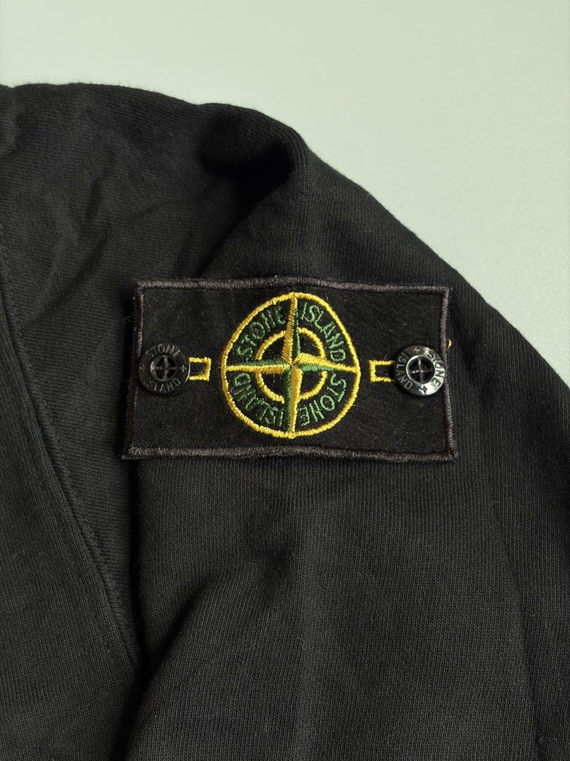 Stone Island Black Sweatshirt (Category: Coats, Jackets and Outerwear) located in Kibawe. Submitted by jeloots (Listing ID 1468085556, Image 3). Description: - Brand: Stone Island - Color: Black - Size: M - Material: 98% cotton, 2% elastane - Design: Classic crewneck with ribbed cuffs and hem - Detail: Signature compass badge buttoned on the left sleeve - Authenticity: Certilogo tag attached inside - Condition: Clean, pre-owned piece.