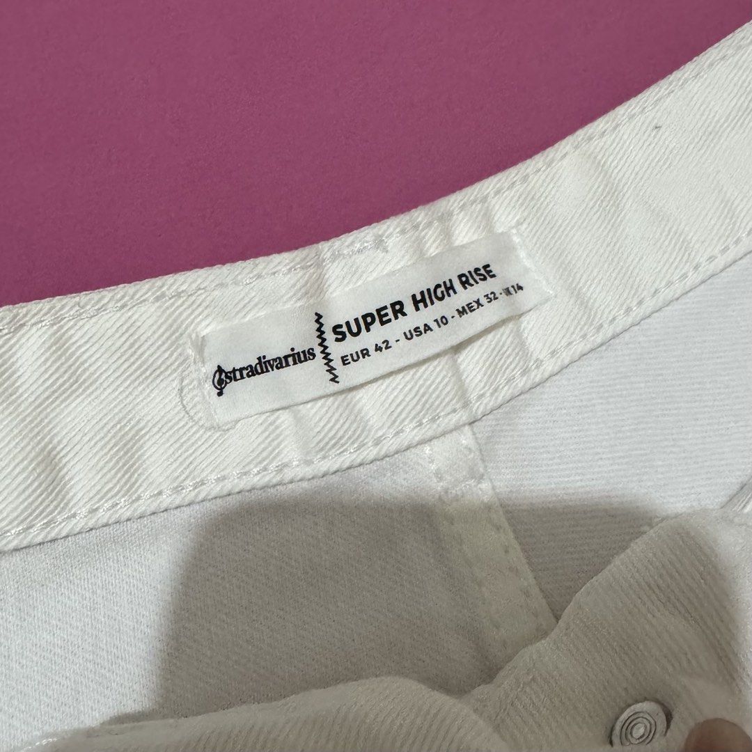 Stradivarius White Denim Shorts with Side Stripes (Category: Shorts) located in San Fernando. Submitted by declotter (Listing ID 1468086211, Image 3). Description: - Brand: Stradivarius - Style: Super high-rise white denim shorts with raw frayed hem - Accent: Chic multicolored side stripe taping on both outer legs - Details: Classic five-pocket design with button fly - Size: EUR 42 / USA 10 / MEX 32 - Condition: Clean and ready to wear.