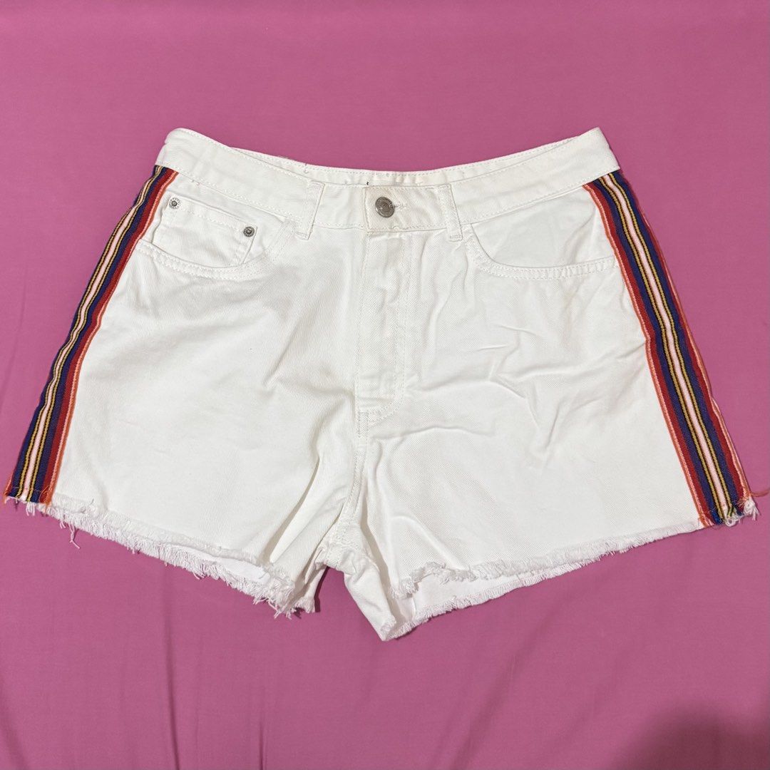 Stradivarius White Denim Shorts with Side Stripes (Category: Shorts) located in San Fernando. Submitted by declotter (Listing ID 1468086211, Image 1). Description: - Brand: Stradivarius - Style: Super high-rise white denim shorts with raw frayed hem - Accent: Chic multicolored side stripe taping on both outer legs - Details: Classic five-pocket design with button fly - Size: EUR 42 / USA 10 / MEX 32 - Condition: Clean and ready to wear.