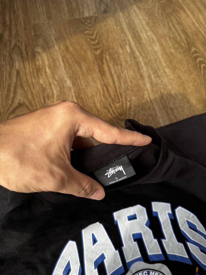 Stussy paris tee (Category: Tshirts & Polo Shirts ) located in Manila. Submitted by isseyboi (Listing ID 1468077545, Image 3). Description: - Brand: Stussy (Paris France Collection) - Size: Large - Material: 100% Cotton (Made in Mexico) - Color: Black - Design: Large arched front text with crest and French flags, small white back neckline logo - Care: Machine washable - Condition: Clean, solid streetwear staple.