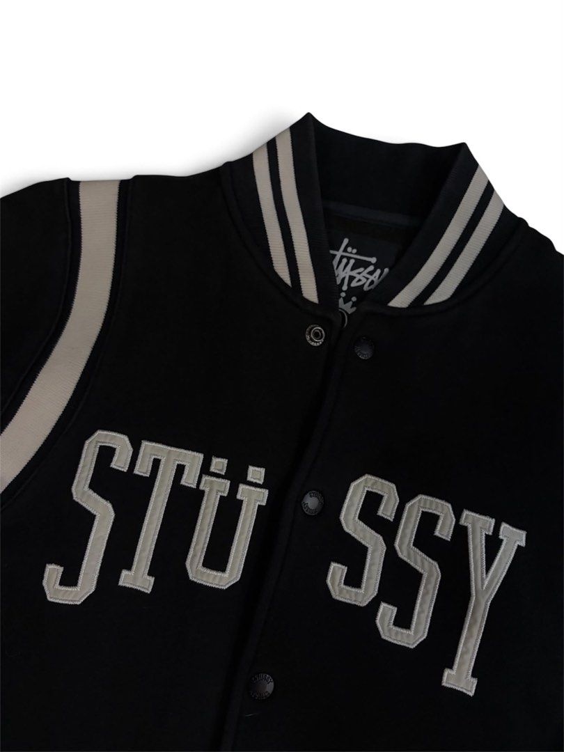 Stussy Varsity Jacket Black Size Small (Category: Coats, Jackets and Outerwear) located in Davao. Submitted by erwin_james (Listing ID 1468175454, Image 2). Description: - Brand: Stussy - Item: Varsity Jacket - Color: Black with cream chenille lettering - Size: Small - Material: 80% cotton, 20% acrylic - Features: Button-up front, striped ribbed collar/cuffs/hem, and side crown logo tag - Origin: Made in China -20x27.