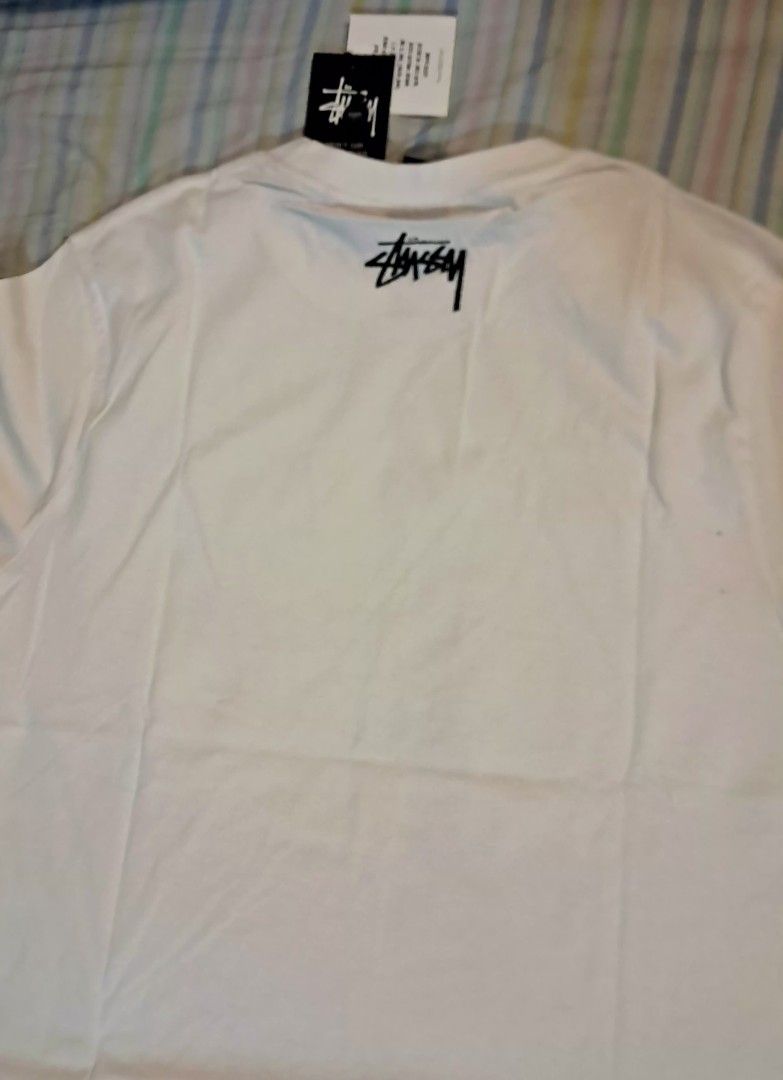 Stussy White T-Shirt (Category: Luxury Apparel) located in Muntinlupa City. Submitted by ch3ll3li (Listing ID 1468176071, Image 3). Description: Writing FOR SALE: White Stüssy-Style Graphic T-Shirt 🤍🖤 ✨ Minimalist Streetwear | Black & White Graphic Print Selling this white graphic T-shirt featuring a vintage-style beach photo and bold black lettering. Perfect for streetwear outfits, casual wear, and everyday styling. Details: Color: White Desig