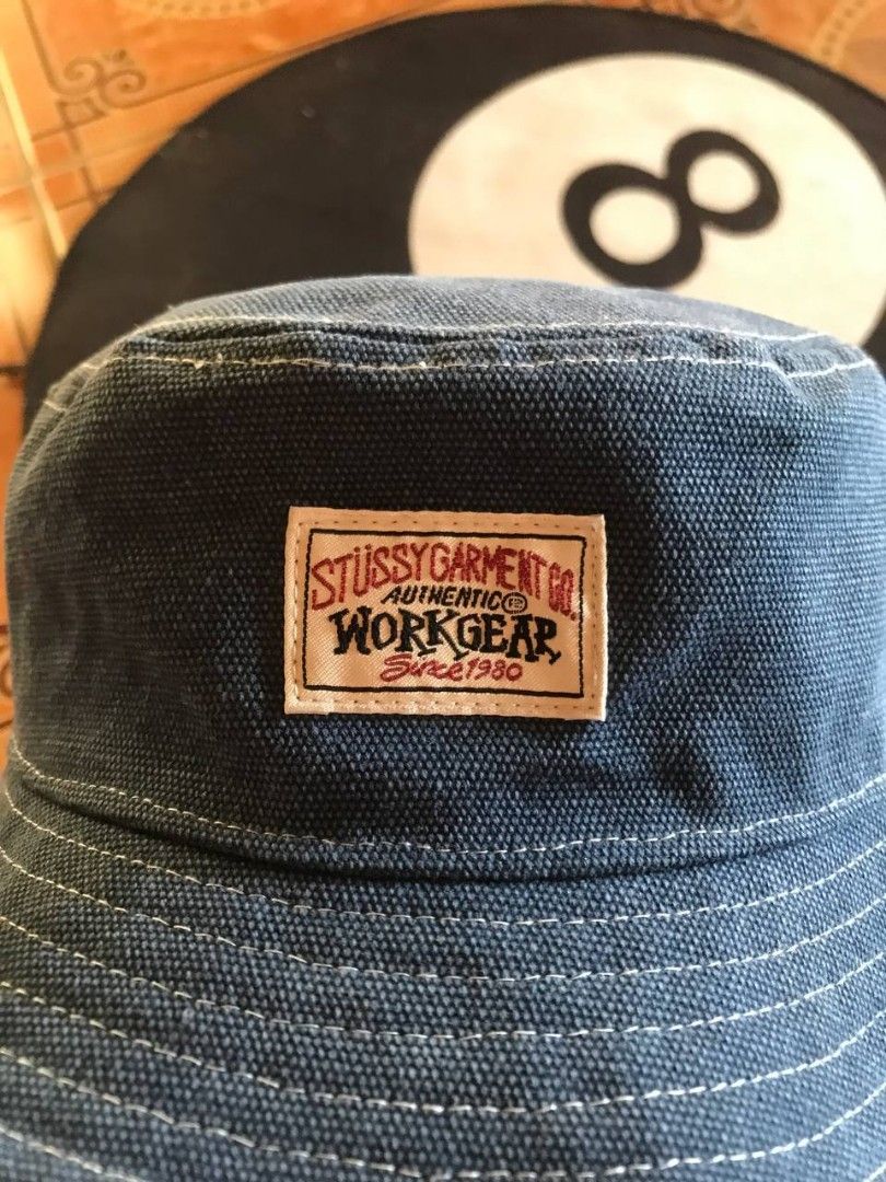 Stussy Workgear Denim Bucket Hat (Category: Caps & Hats) located in Bayambang. Submitted by marvinarenasph (Listing ID 1468216280, Image 2). Description: Brand: Stussy Item: Workgear Bucket Hat Color: Blue Denim with white contrast stitching 23 Year Old Model Adult Material: 50% Cotton, 50% Polyester blend Details: Authentic front workgear patch and inner style tag #132108 Condition: Clean inside and out, great streetwear piece.