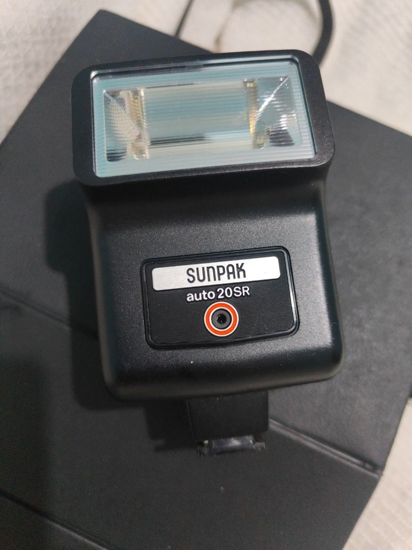Sunpak Auto 20SR Thyristor Camera Flash (Category: Flashes) located in Manila. Submitted by wuxue998 (Listing ID 1468192658, Image 1). Description: - Vintage Sunpak Auto 20SR thyristor camera flash, Made in Japan - Standard hot shoe mount compatible with various film cameras - Manual and automatic exposure modes with rear DIN/ASA speed dial - Includes ready/test button and sync port - Clean exterior body, well-maintained retro photography accesso