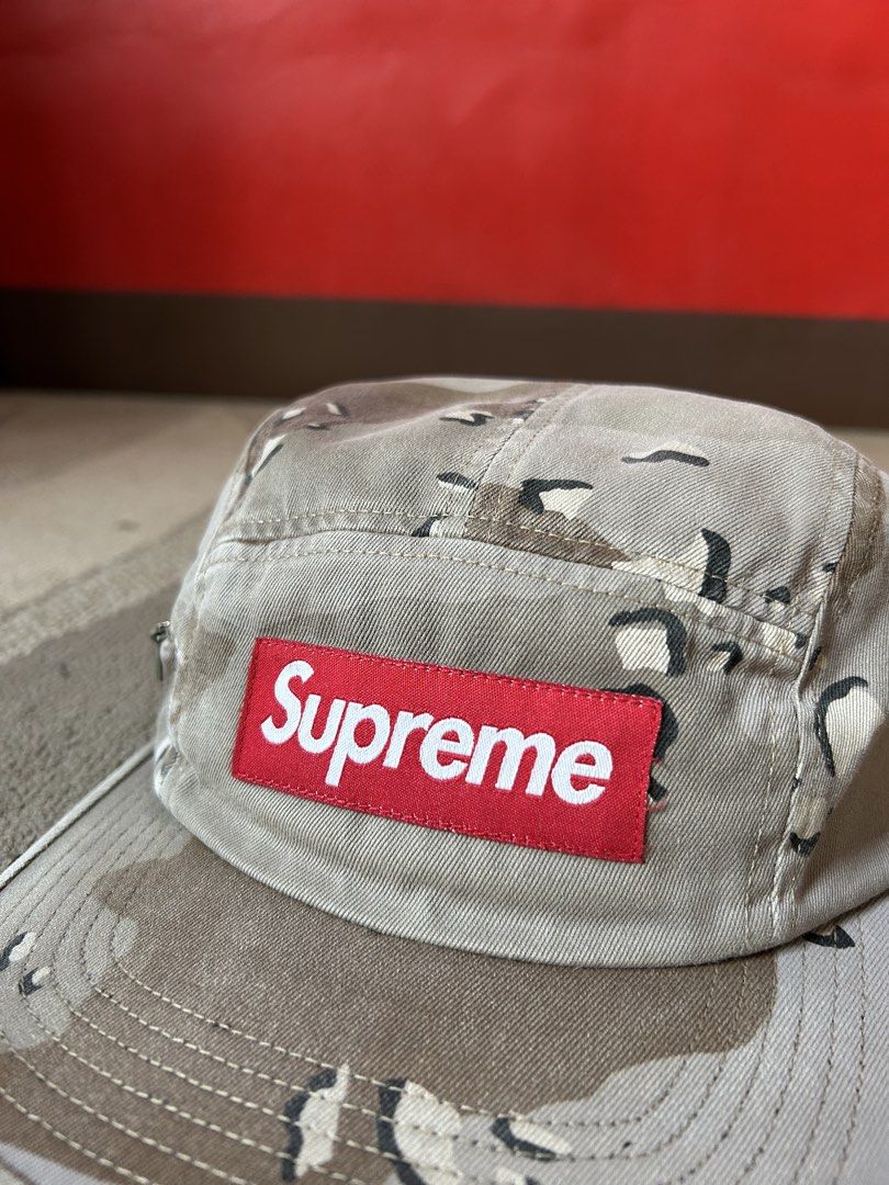 Supreme Dessert Camou Camp Cap (Category: Caps & Hats) located in Abucay. Submitted by stuttt (Listing ID 1468174506, Image 2). Description: - Authentic Supreme desert camouflage camp cap - Classic 5-panel design with a flat brim - Iconic red box logo on the front - Adjustable black strap closure for a custom fit - Features the Made in USA tag - Clean exterior and interior, great for everyday streetwear.