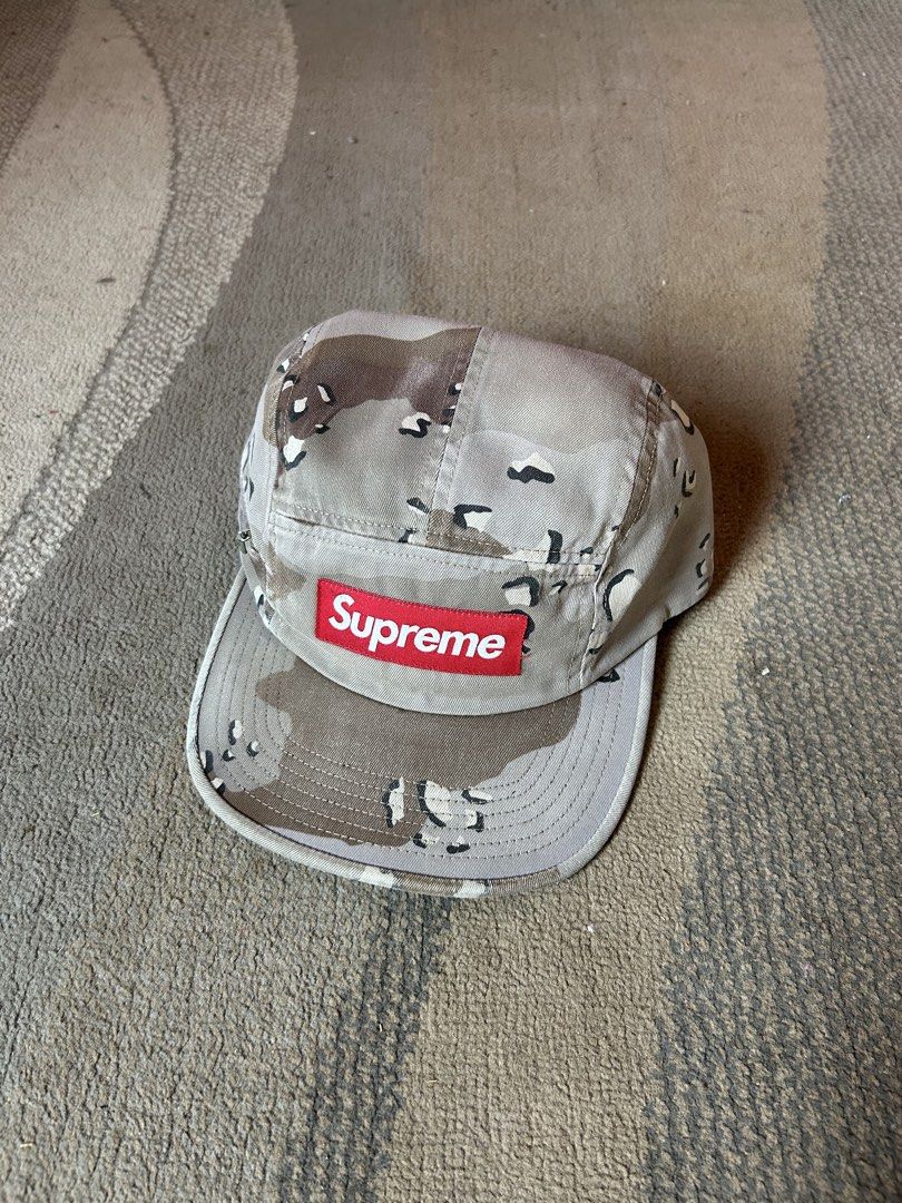 Supreme Dessert Camou Camp Cap (Category: Caps & Hats) located in Abucay. Submitted by stuttt (Listing ID 1468174506, Image 1). Description: - Authentic Supreme desert camouflage camp cap - Classic 5-panel design with a flat brim - Iconic red box logo on the front - Adjustable black strap closure for a custom fit - Features the Made in USA tag - Clean exterior and interior, great for everyday streetwear.