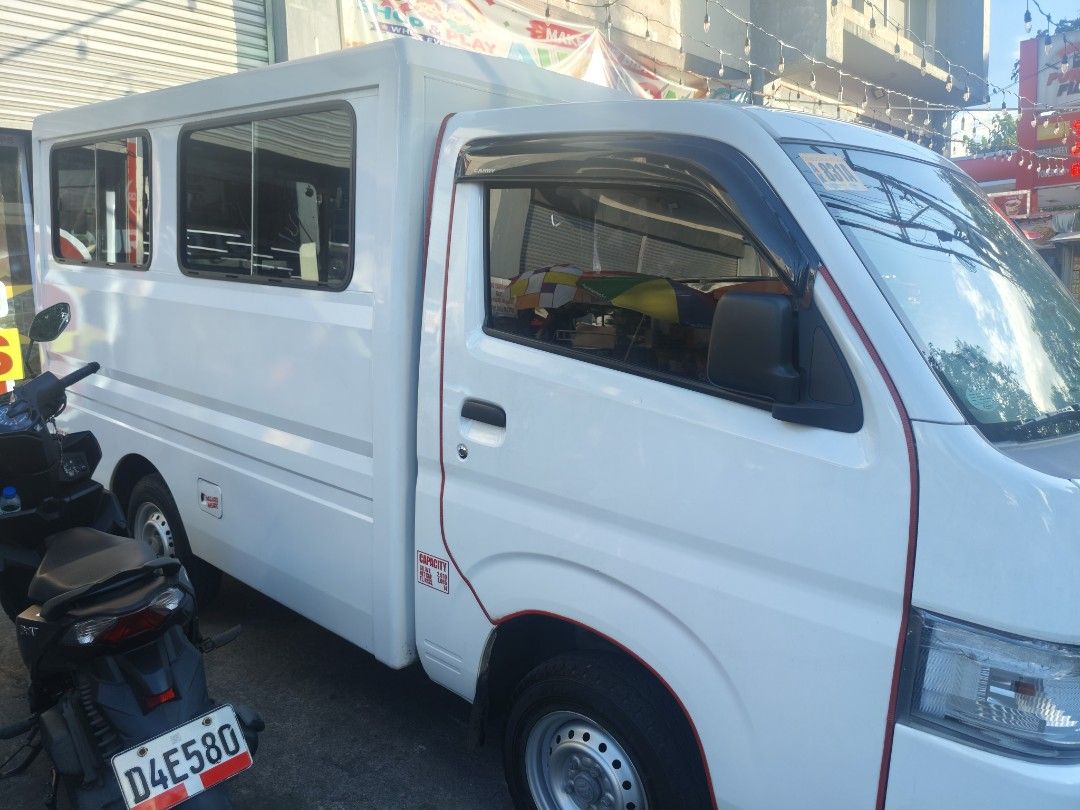 Suzuki Carry UV Manual (Category: Used Cars) located in Manila. Submitted by zealdragon.e46f60 (Listing ID 1468168671, Image 2). Description: QUICK SPECS: Transmission: Manual (MT) Engine: 1.5L Gas (Very healthy, smooth drive) Body: FB Utility Van with sliding windows Status: Private use / Not For Hire CONCESSIONS (See Photos): Cracked right headlight lens (bulb works, needs new headlight lens) Minor dent with paint chip on side panel Shallow scr