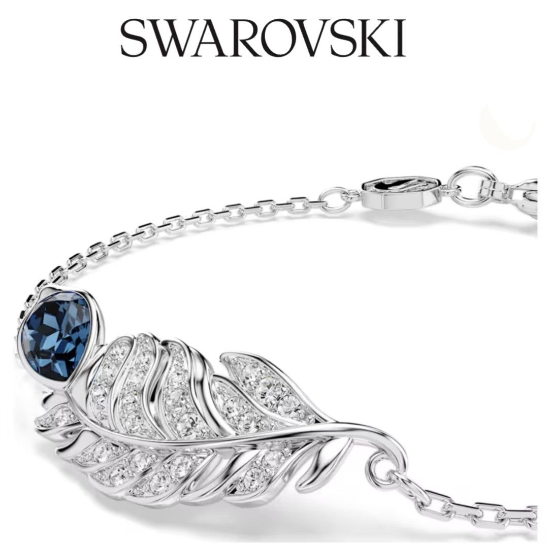 Swarovski Nice Feather Blue Crystal Silver Bracelet (Category: Bracelets) located in Bacoor. Submitted by ourpersonalstuffs (Listing ID 1468065303, Image 1). Description: Swarovski bracelet with a detailed feather centerpiece, pavé crystals, and a deep blue stone. Rhodium plated finish. Adjustable chain featuring a dangling crystal charm at the end and the iconic Swarovski swan tag near the lobster clasp. Delicate look on the wrist, catches the l