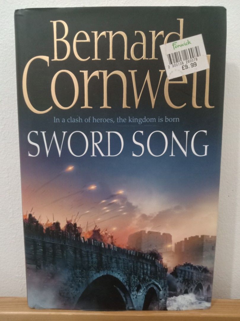 Sword Song by Bernard Cornwell (Category: Storybooks) located in Bacolor. Submitted by appletun (Listing ID 1468156795, Image 1). Description: - Title: Sword Song by Bernard Cornwell - Series: Part of The Saxon Stories - Format: Hardbound with striking battle scene cover - Subtitle: In a clash of heroes, the kingdom is born - Price Tag: Original Fenwick sticker of £9.99 attached - Genre: Historical Fiction.