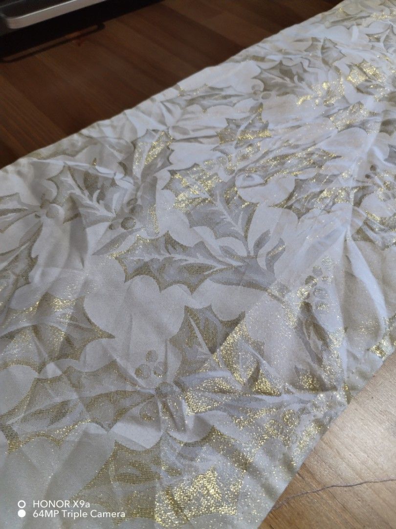 Table Runner (Category: Towels, Napkins & Holders) located in Muntinlupa City. Submitted by arciagamaryann68 (Listing ID 1468107193, Image 3). Description: - Color: White with metallic gold details - Design: Festive holly leaf pattern - Feature: Elegant hanging tassels on both ends - Ideal for: Dining tables, holiday parties, and home decor - Condition: Good pre-owned/ready-to-use condition.