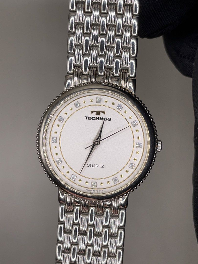 Technos Quartz Watch Swiss Made Silver Tone (Category: Men's Watches) located in Pateros City. Submitted by thevintagepatt_ (Listing ID 1468232773, Image 1). Description: Technos quartz watch with a textured white dial and crystal markers. Round silver case with a beaded bezel. Linked metal bracelet strap. Swiss M TE-063 stamped on the dial. Clean design, classic daily wear piece..