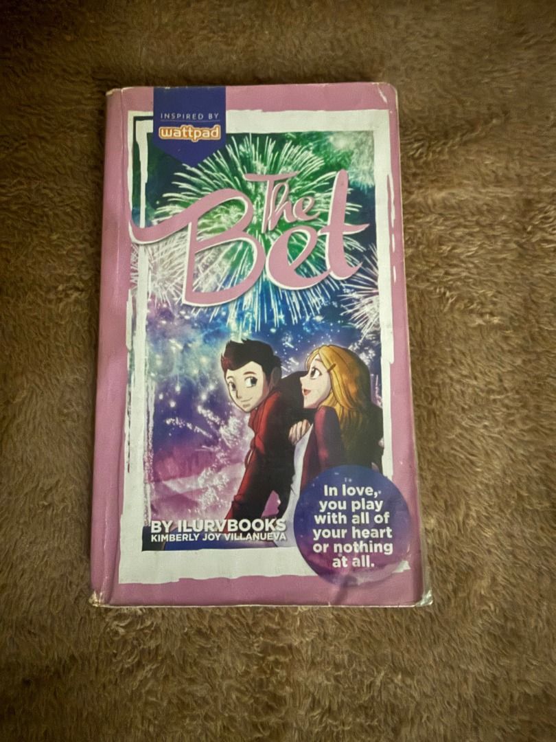 The Bet by ilurvbooks (Category: Storybooks) located in Manila. Submitted by vaultfinds (Listing ID 1468267472, Image 1). Description: Popular Wattpad romance novel titled The Bet. Written by Kimberly Joy Villanueva, also known as ilurvbooks. Paperback edition with illustrated cover showing characters under fireworks. Classic young adult fiction story. Pages intact, readable copy for fans of local teen fiction and Wattpad books..