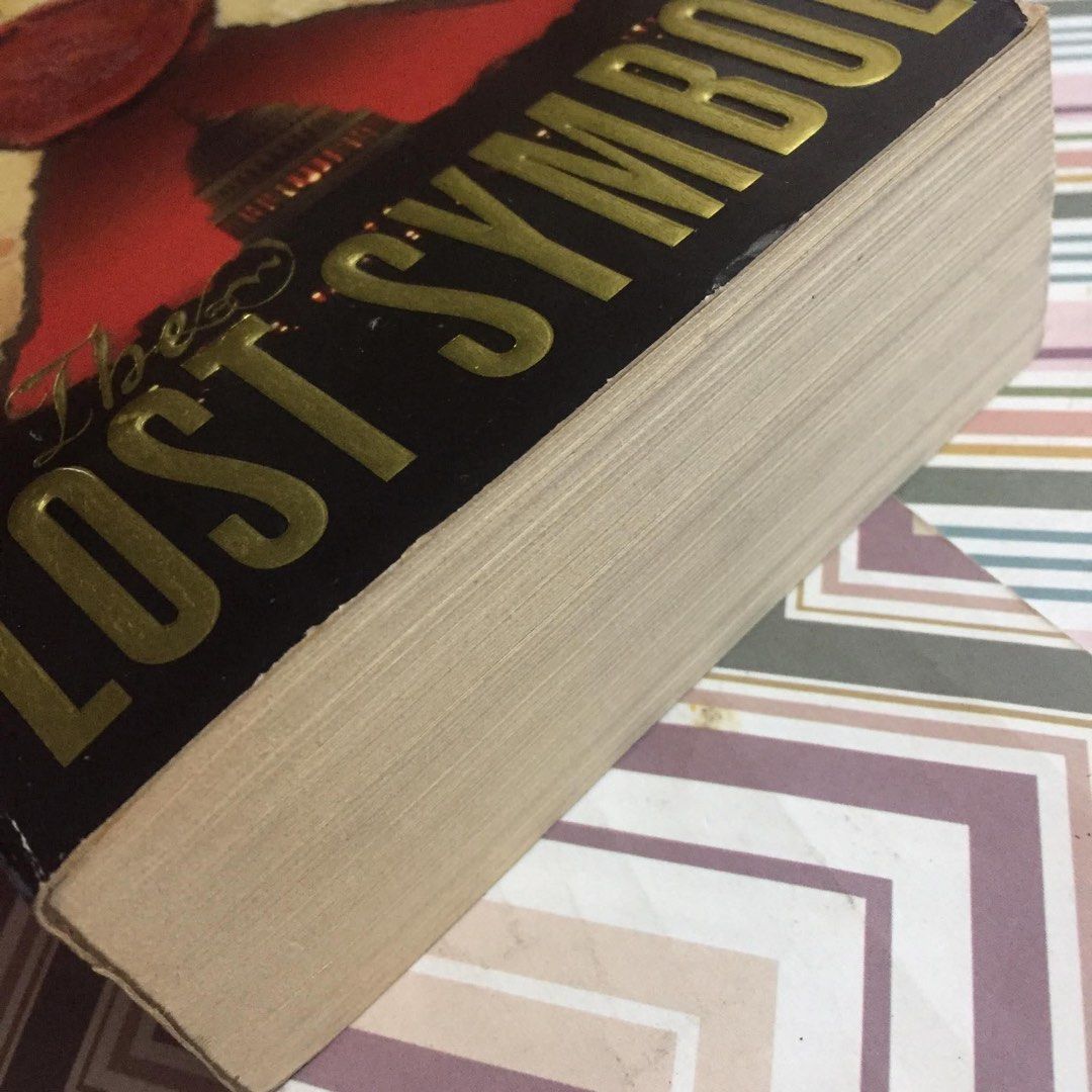 The Lost Symbol by Dan Brown (Category: Storybooks) located in Pasig City. Submitted by sell.phi (Listing ID 1468142415, Image 2). Description: The Lost Symbol Dan Brown Preloved mass market paperback with pen marks on the first page with creases on the covers and spine tanned inside covers, pages, and edges .