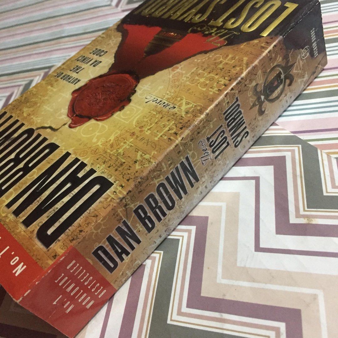 The Lost Symbol by Dan Brown (Category: Storybooks) located in Pasig City. Submitted by sell.phi (Listing ID 1468142415, Image 3). Description: The Lost Symbol Dan Brown Preloved mass market paperback with pen marks on the first page with creases on the covers and spine tanned inside covers, pages, and edges .