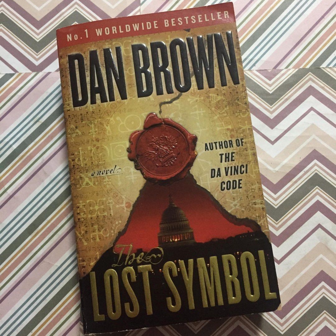 The Lost Symbol by Dan Brown (Category: Storybooks) located in Pasig City. Submitted by sell.phi (Listing ID 1468142415, Image 1). Description: The Lost Symbol Dan Brown Preloved mass market paperback with pen marks on the first page with creases on the covers and spine tanned inside covers, pages, and edges .