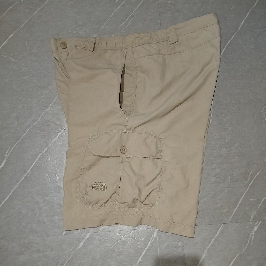 The North Face Beige Cargo Shorts (Category: Shorts) located in Davao. Submitted by vernoneighty4 (Listing ID 1467476896, Image 3). Description: - Brand: The North Face - Color: Classic Beige - Material: Durable, quick-dry nylon - Features: Multiple button-flap cargo pockets for storage - Comfort: Elastic waistband panels on the sides - Details: Embroidered logo on the lower left leg, standard button closure, and zip fly - Ideal for: Hiking, outd