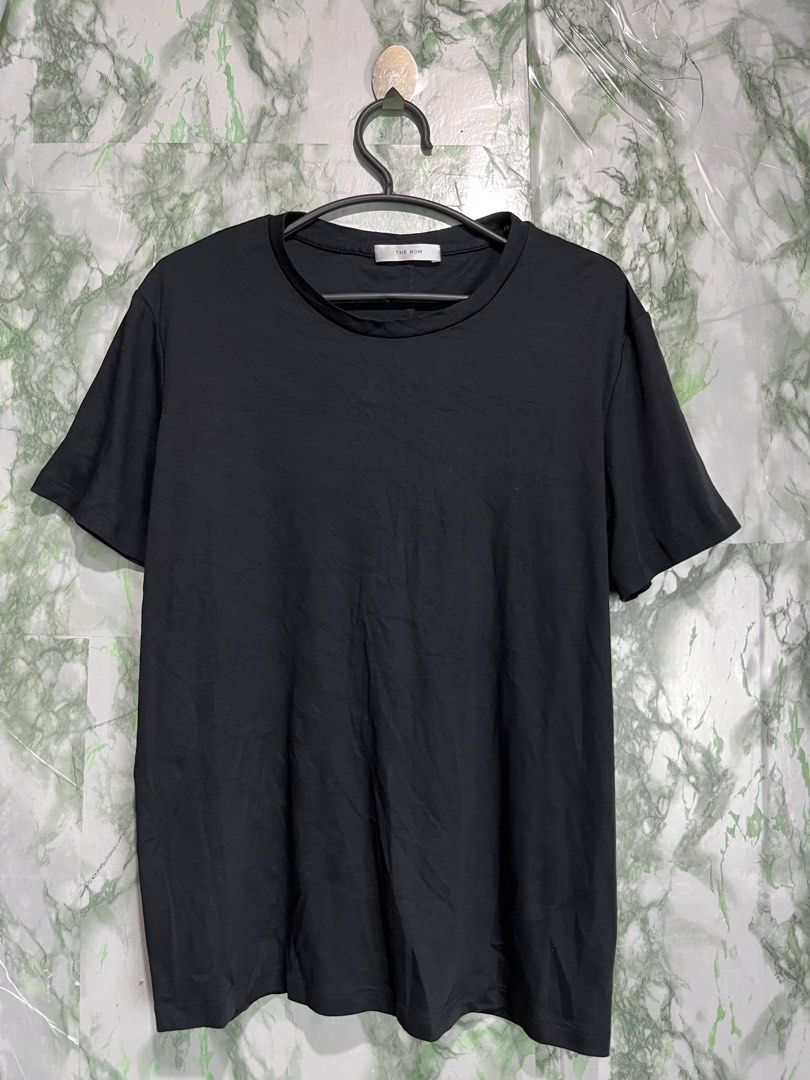 THE ROW T-shirt (Category: Shirts) located in Bulacan. Submitted by letsfindukaywithme (Listing ID 1468064490, Image 2). Description: The Row T-shirt XL 19x24" Cotton strechable like new No issue +sf payment first Ship via J&T.