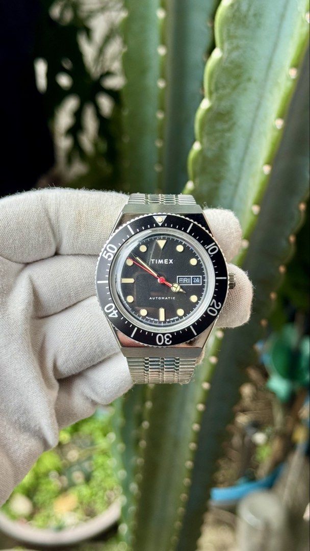 Timex M79 Automatic Watch (Category: Men's Watches) located in Manila. Submitted by junjun12356 (Listing ID 1468282349, Image 1). Description: - Brand: Timex M79 Automatic - Dial: Black with day-date window at 3 o'clock - Bezel: Rotating bezel - Case & Bracelet: Stainless steel with polished finish - Movement: Automatic mechanical movement with exhibition case back - Crown: Signed with Timex logo - Condition: Clean crystal, well-maintained - Size