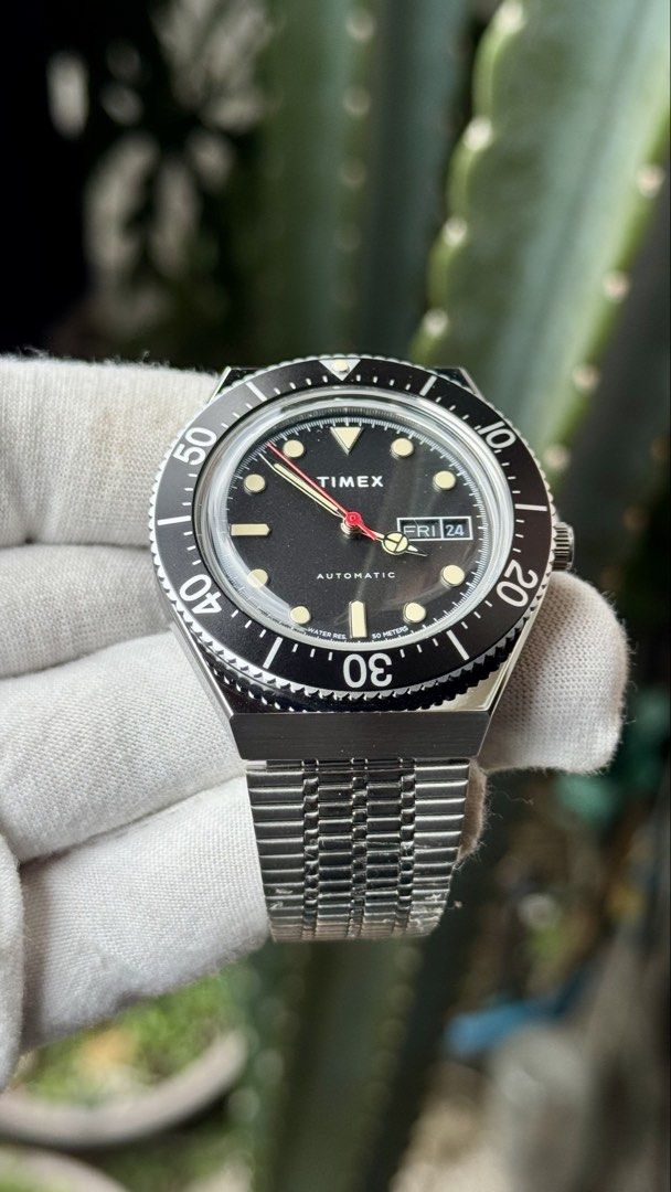 Timex M79 Automatic Watch (Category: Men's Watches) located in Manila. Submitted by junjun12356 (Listing ID 1468282349, Image 2). Description: - Brand: Timex M79 Automatic - Dial: Black with day-date window at 3 o'clock - Bezel: Rotating bezel - Case & Bracelet: Stainless steel with polished finish - Movement: Automatic mechanical movement with exhibition case back - Crown: Signed with Timex logo - Condition: Clean crystal, well-maintained - Size