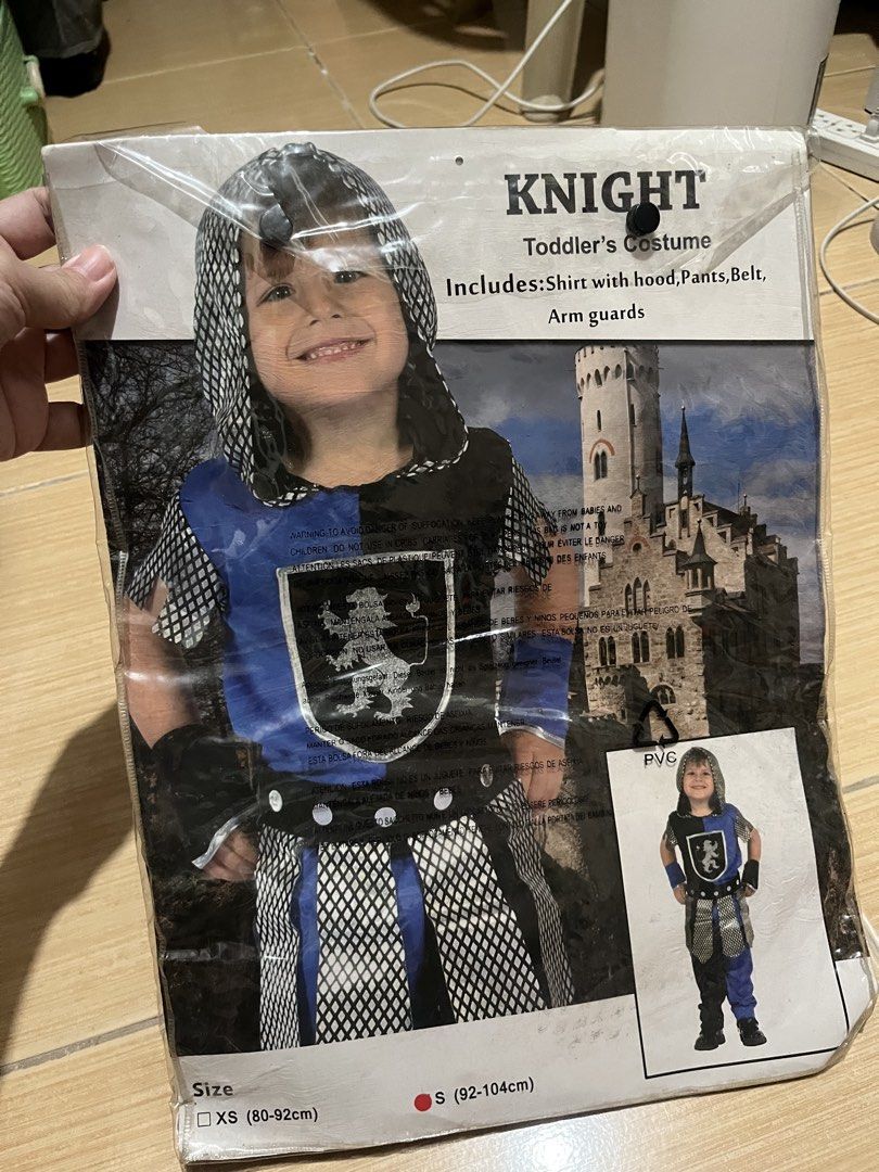 Toddler Knight Costume (Category: Babies & Kids Fashion) located in Quezon City. Submitted by lovedbykarlaa (Listing ID 1468067703, Image 1). Description: - Size: S (fits toddlers 92 to 104cm in height) - Color: Blue and black - Complete Set: Includes shirt with attached hood, pants, belt, and arm guards - Design Details: Features a cool lion crest shield emblem on the chest and stylish mesh fabric on the sleeves and skirt overlay - Condition: Co