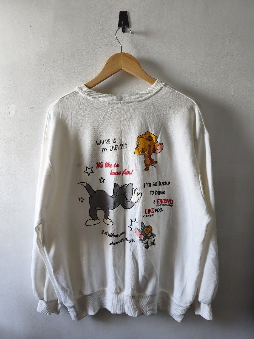 Tom and Jerry White Graphic Sweatshirt Size L Code B9 (Category: Coats, Jackets and Outerwear) located in Manila. Submitted by gelog2 (Listing ID 1468144531, Image 2). Description: - Item: White Tom & Jerry Sweater - Size: L (Measures 27.5" length x 23" width) - Design: Small cheese graphic on front left chest; large Tom & Jerry graphic and quotes ("Where is my cheese?", "We like to have fun") on the back - Condition: Excellent, rated 8.5/10.