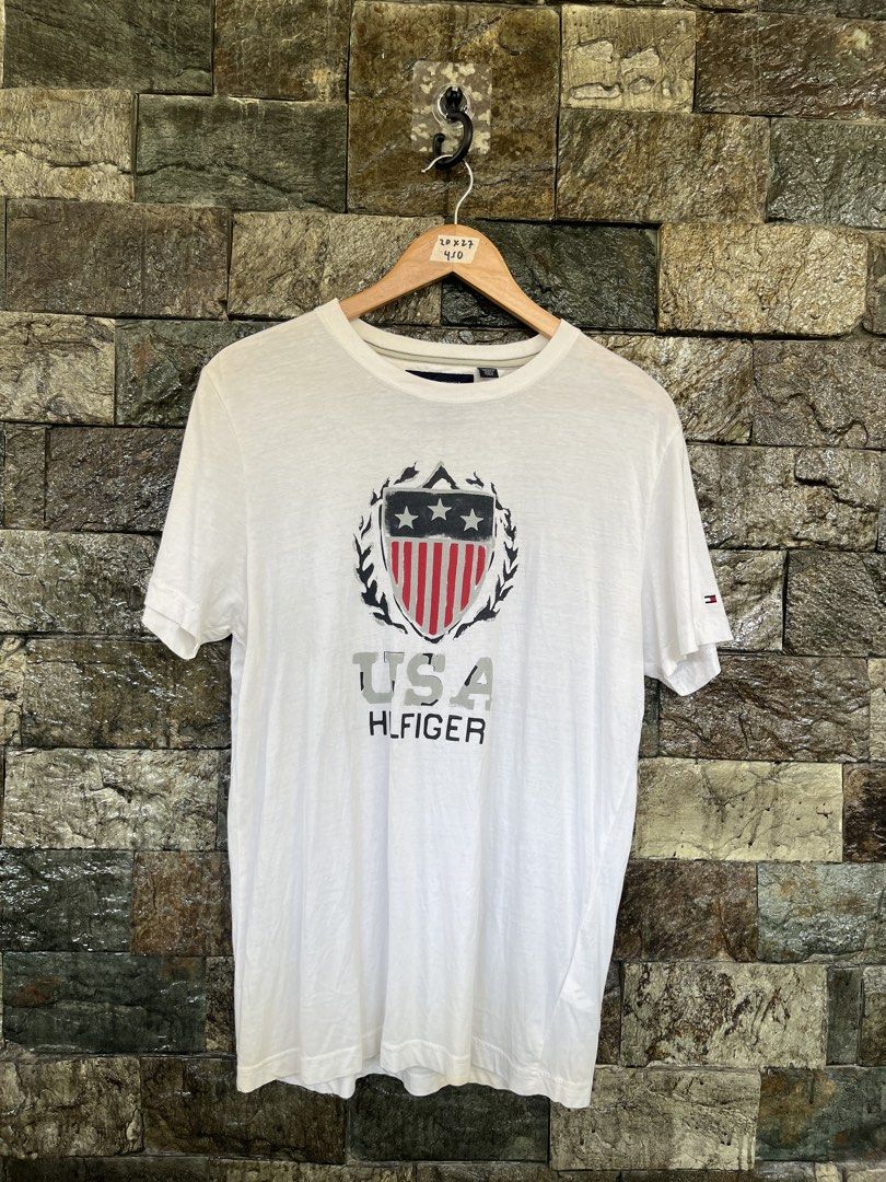 Tommy Hildiger USA White Shirt (Category: Tshirts & Polo Shirts ) located in Cagayan de Oro. Submitted by curatedheirloomph_ (Listing ID 1468225829, Image 1). Description: 𝘿𝙞𝙢𝙚𝙣𝙨𝙞𝙤𝙣𝙨: 20x27 𝘽𝙚𝙨𝙩 𝙁𝙞𝙩: Medium 𝘾𝙤𝙣𝙙𝙞𝙩𝙞𝙤𝙣 & 𝘾𝙤𝙡𝙤𝙧 𝙍𝙖𝙩𝙚: Excellent (9.5/10) 𝙄𝙨𝙨𝙪𝙚: N/A 𝘼𝙪𝙩𝙝𝙚𝙣𝙩𝙞𝙘𝙞𝙩𝙮 𝘿𝙚𝙘𝙡𝙖𝙧𝙖𝙩𝙞𝙤𝙣: Authentic.